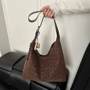 Brown leopard print hobo bag with striped tassel charm and silver ring strap connector