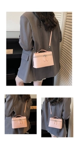 Detail showing pink ostrich embossed square box bag with dual zippers and silver hardware