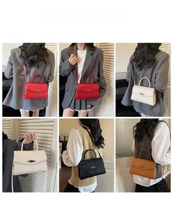 Model display of minimalist vintage flap handbag with metallic swivel lock and strap