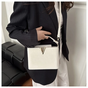 Business look with white textured leather handbag featuring a gold V-shaped metal buckle