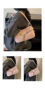 Detail of light pink pebble leather baguette bag with silver chain and heart charm