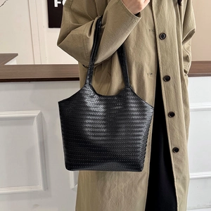 Classic black woven texture tote bag for women showing a stylish commute look