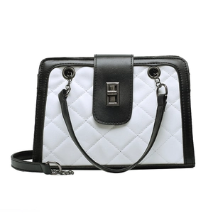 Chic quilted crossbody bag with black and white contrast leather and metal chain strap
