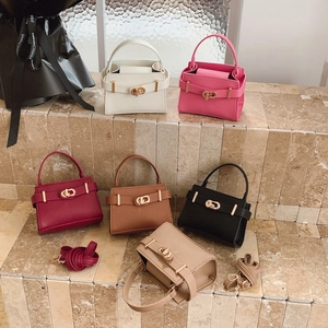 Chic mini satchel handbags in six colors with gold metal buckles on stone steps