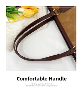 Detail of comfortable brown matte leather handle and gold metal ring on tote bag