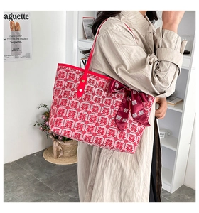 Detail of red jacquard wedding tote featuring Double Happiness motif and satin bow