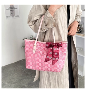 Detailed view of pink bridal tote with traditional Xi character jacquard and red bow