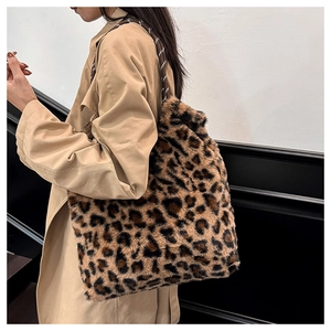 Close-up of leopard print plush tote bag with woven handles on a fashion model
