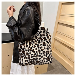 Leopard print plush tote bag shown on a model with minimalist indoor background