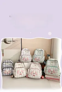 Detail view of stylish plaid school backpacks in six soft pastel colors with puppy patches