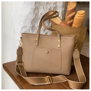 Detail of khaki tote bag with litchi grain leather and detachable fabric shoulder strap