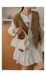 Détail du sac nuage blanc cassé en cuir souple avec bandoulière porté par mannequin
