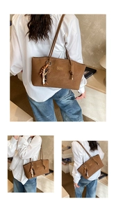 Detail of brown suede tote bag featuring a bohemian beaded tassel and gold logo plaque