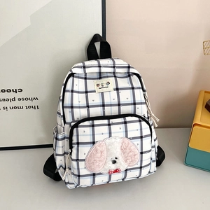 Plaid school backpack for girls with blue-grey checkered patterns and plush dog patch