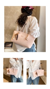 Detail of light pink leather tote bag with metallic CHILLON logo and beaded charm