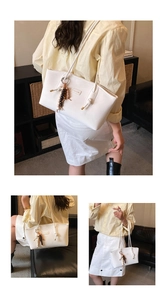 Detail of white PU leather tote bag featuring Chillo logo patch and wooden bead tassel