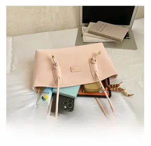 Pink tote bag interior showing large capacity for phone, tablet, and daily essentials
