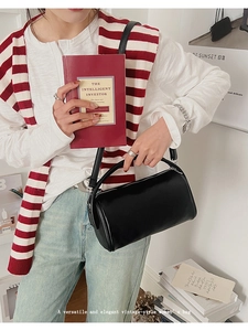 Schicke Vintage Zylinder-Handtasche aus schwarzem Leder mit Griff und Schultergurt