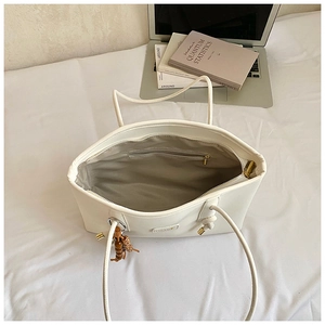 Internal view of off-white tote bag with zipper pocket, laptop and books inside