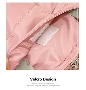 Detail of pink quilted laptop bag with secure white velcro closure and metal zipper