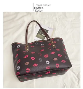 Detailed top view of a brown tote bag with colorful lip prints and gold rivets on a magazine