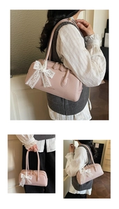 Pink Boston bag detail featuring litchi texture material and white lace bow decoration