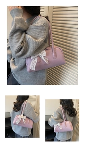 Close-up of light purple Boston bag with litchi texture and white lace bow detail
