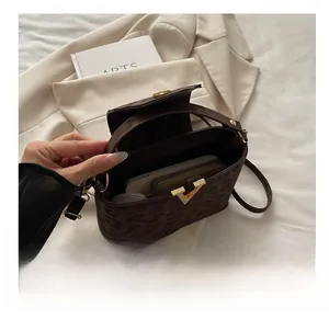 Detailed view of the spacious interior of a leopard print handbag with a gold V-shaped clasp