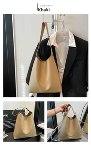 Detail view of khaki faux leather tote bag with FASHION lettering and spacious interior