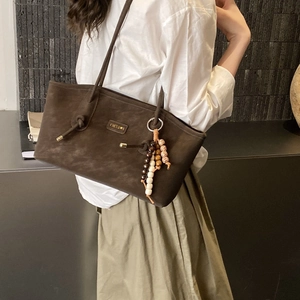 Minimalist coffee brown tote bag in matte suede leather with decorative beaded charm
