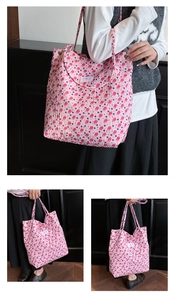 Detail of pink pleated tote bag showing textured floral print and white brand label