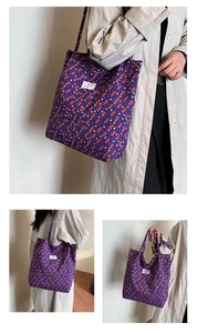 Detail of purple quilted tote bag with colorful dot pattern and textile logo label