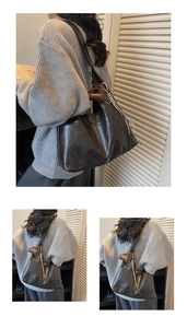 Detail of dark grey leather tote bag featuring a decorative brown branded hangtag charm