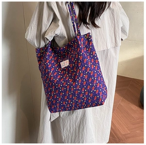 Detail of purple floral tote bag showing pleated fabric texture and Tianyu label