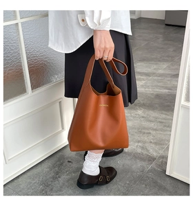 Caramel brown leather tote bag with gold FASHION lettering for stylish commute look