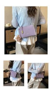 Detail of purple rectangle box bag with CHUDON logo and brown plush bear charm