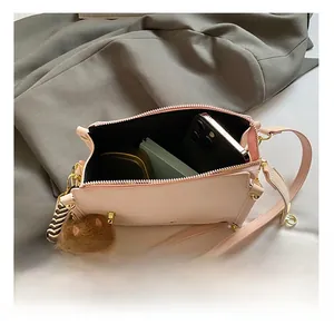 Top view showing spacious interior of pink PU leather crossbody bag with cute dog charm