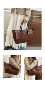 Close-up of brown crocodile embossed tote bag with flap closure and vintage texture
