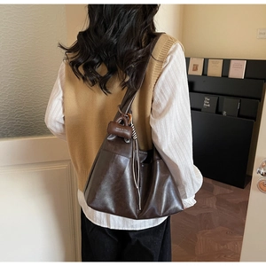 Detail of soft dark coffee faux leather tote with Maven & Chic brand tag and woven cord