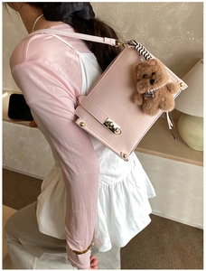 Pink rectangular shoulder bag with golden lock and cute plush bear charm detail