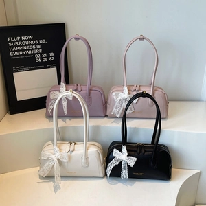 Elegant Boston handbags in various colors with lace bows and gold branding