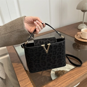 Structured leopard print tote bag with gold V-logo hardware and leather top handle