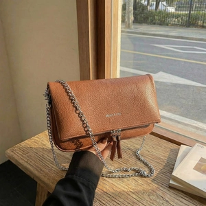 Chic caramel lychee pattern leather crossbody bag with silver chain and fringe details