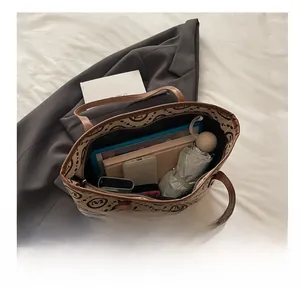 Spacious interior of canvas tote bag filled with tablet, phone, and daily essentials