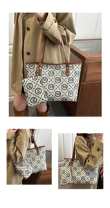 Detail view of stylish tote bag set with M-logo print and brown leather handles