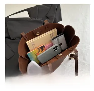 Detail view of brown tote bag interior capacity with magnetic closure and matte leather