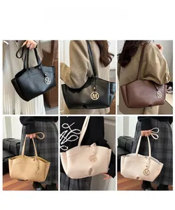 Detail view of large capacity tote bag in four colors with stylish metal pendant