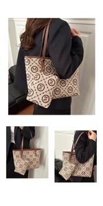 Macro view of monogram print tote bag and matching small pouch set with leather trim