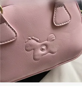 Macro view of pink lychee grain PU leather with embossed pony pattern and fine stitching