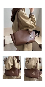 Detailed view of brown leather tote bag with elegant gold M-letter charm and slim straps